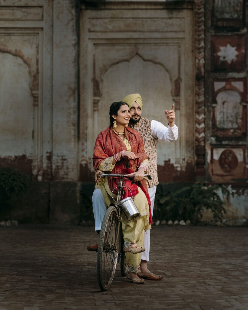 Fun pre-wedding shoot with couple on bicycle capturing candid moments