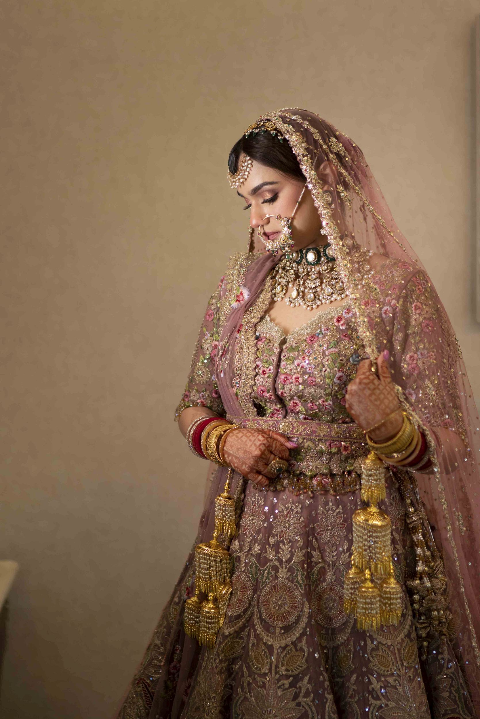 Elegant portrait of Sikh bride Bismin in pastel lehenga during wedding day