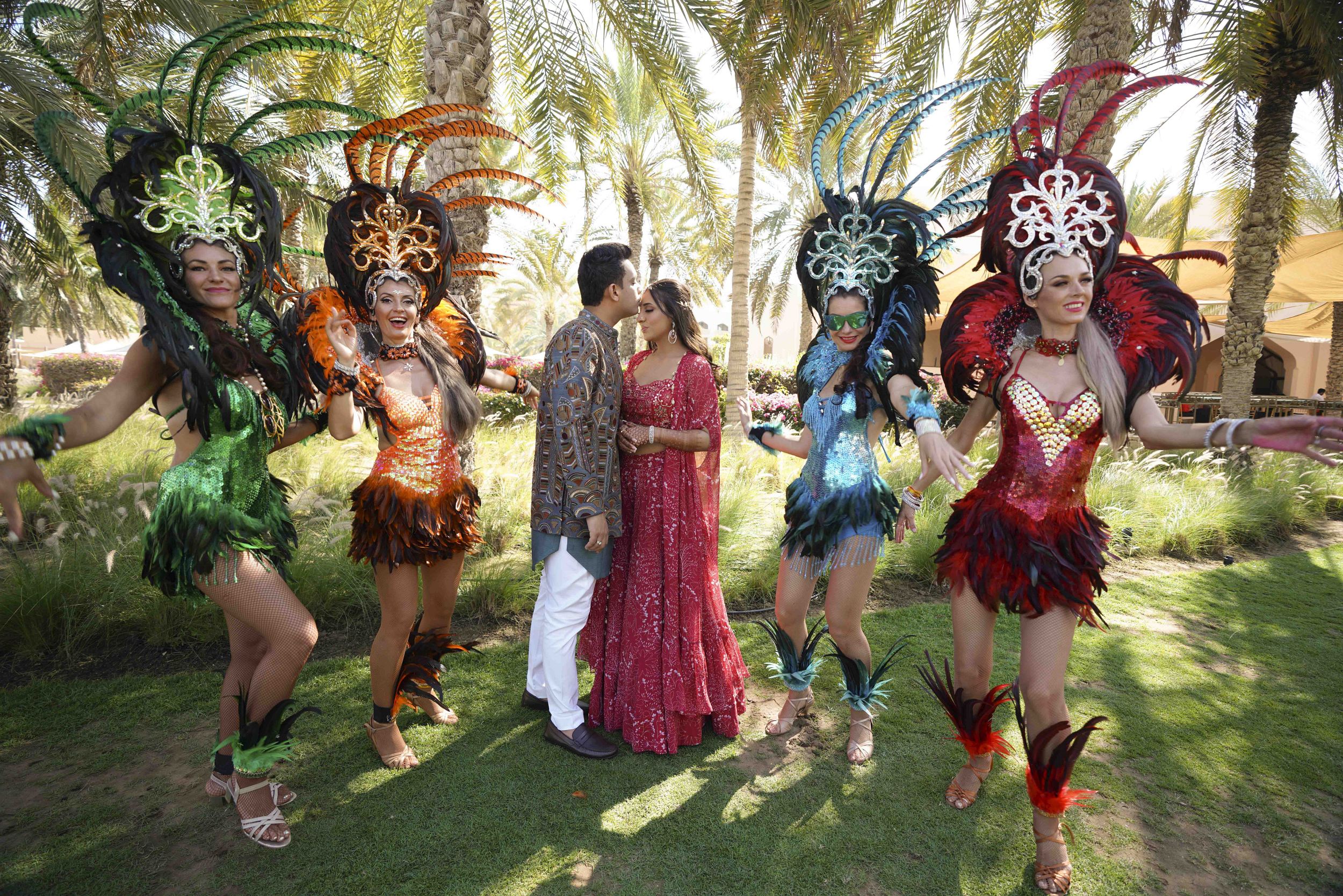 Performers dressed in traditional attire dancing at wedding celebration