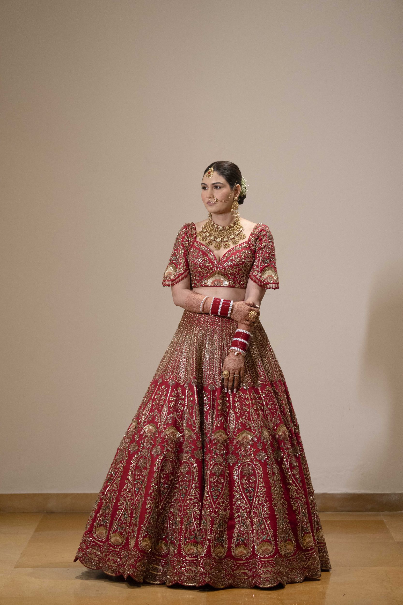 Bride standing in full wedding attire during Hindu wedding