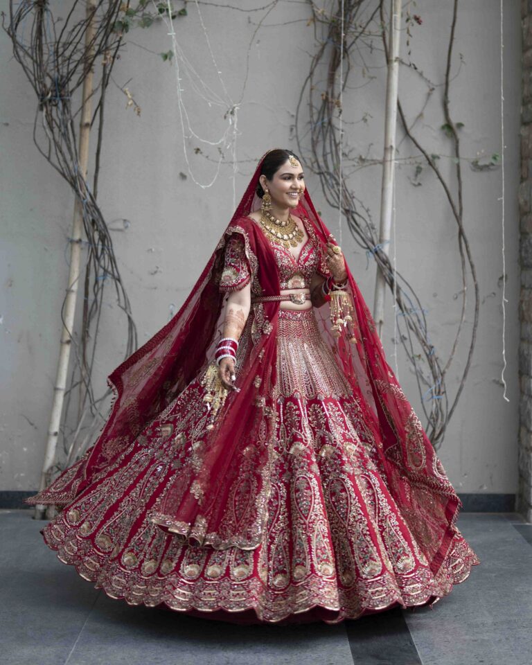 bride-full-outfit-red-lehenga-portrait-05 Elegant full bridal portrait showcasing red lehenga dupatta and traditional jewelry details