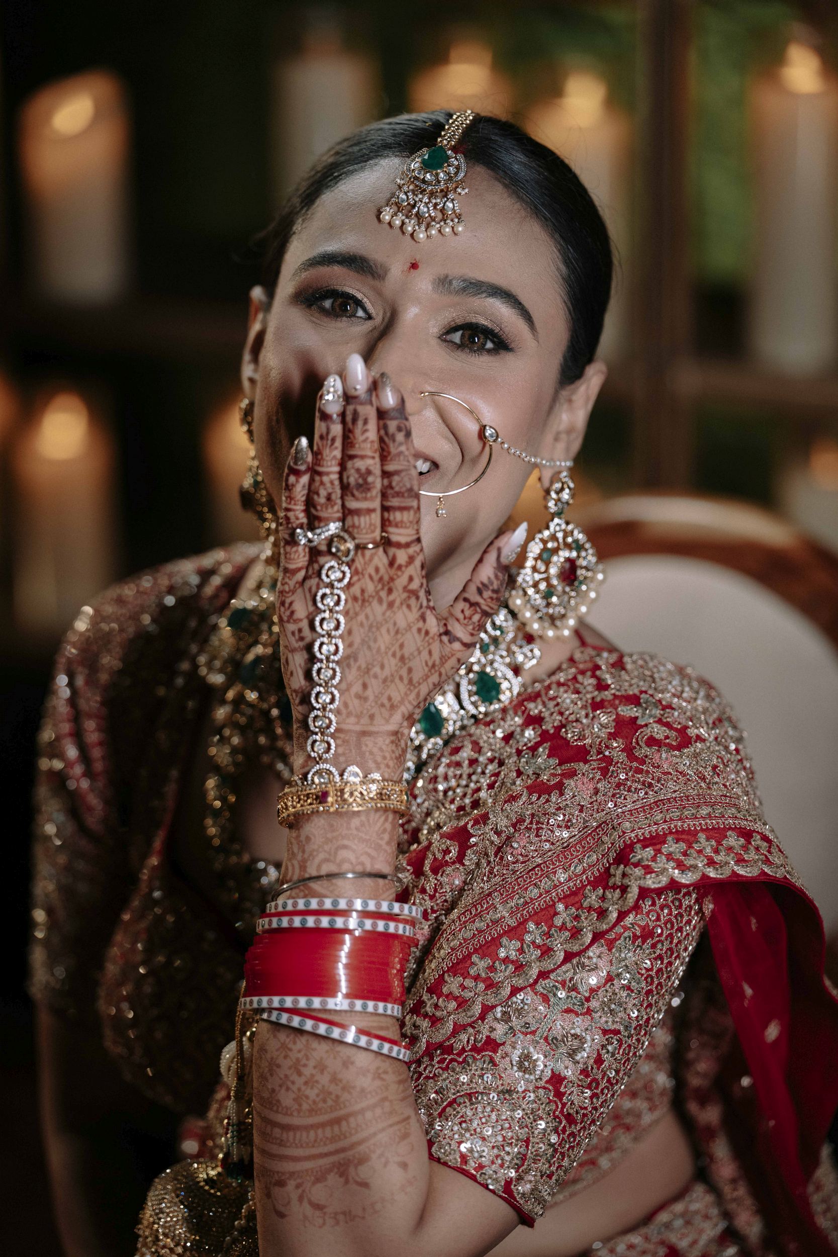 Bridegroom portrait showing her red saree, nose nath and tikka jewelery