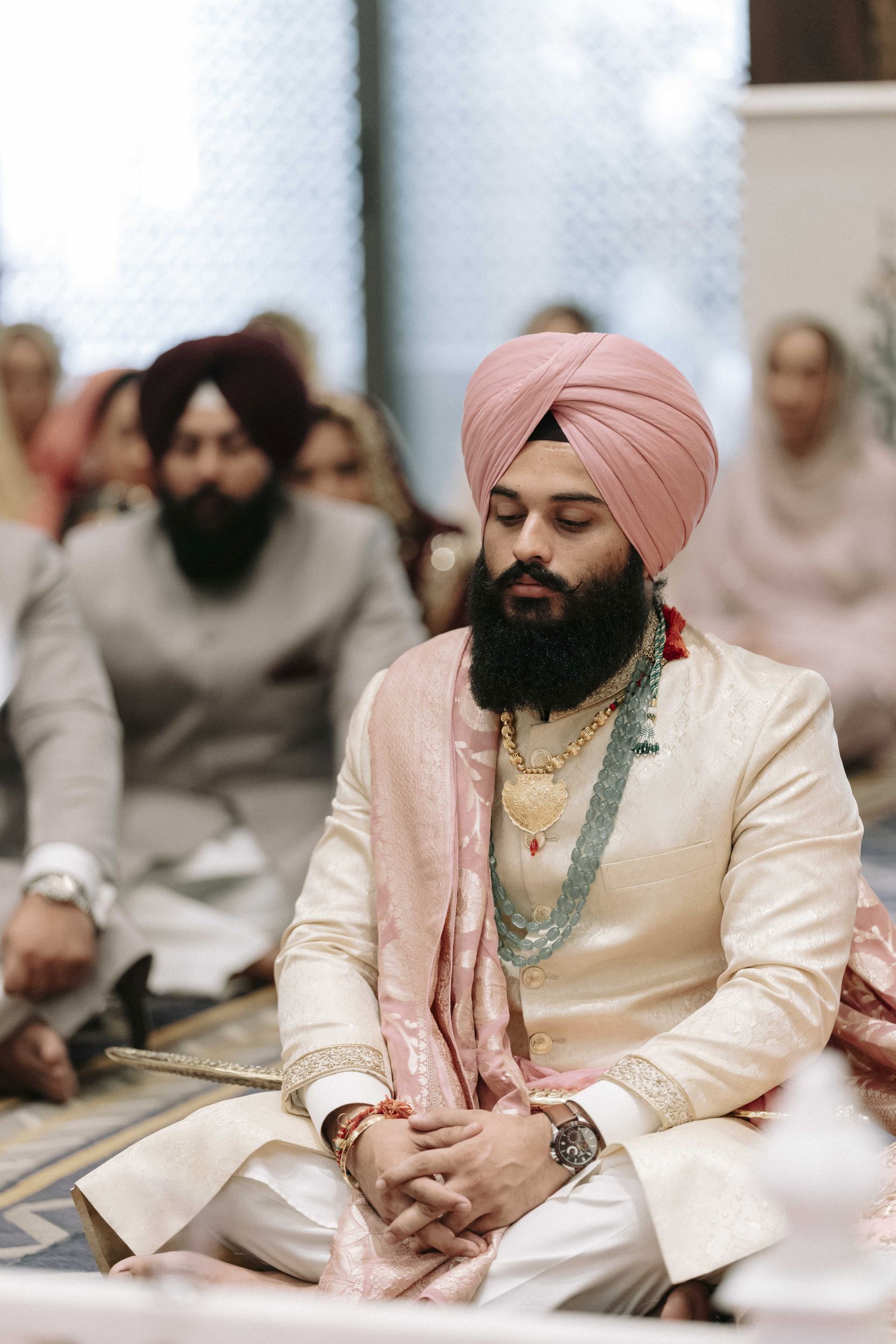 Groom posing in traditional wedding attire